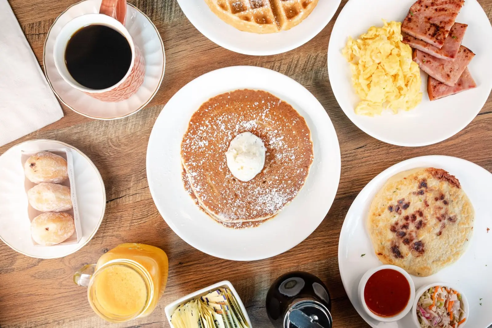 Breakfast spread at Westlake Coffee Shop — pancakes, waffles, ham and eggs, pupusas, and coffee