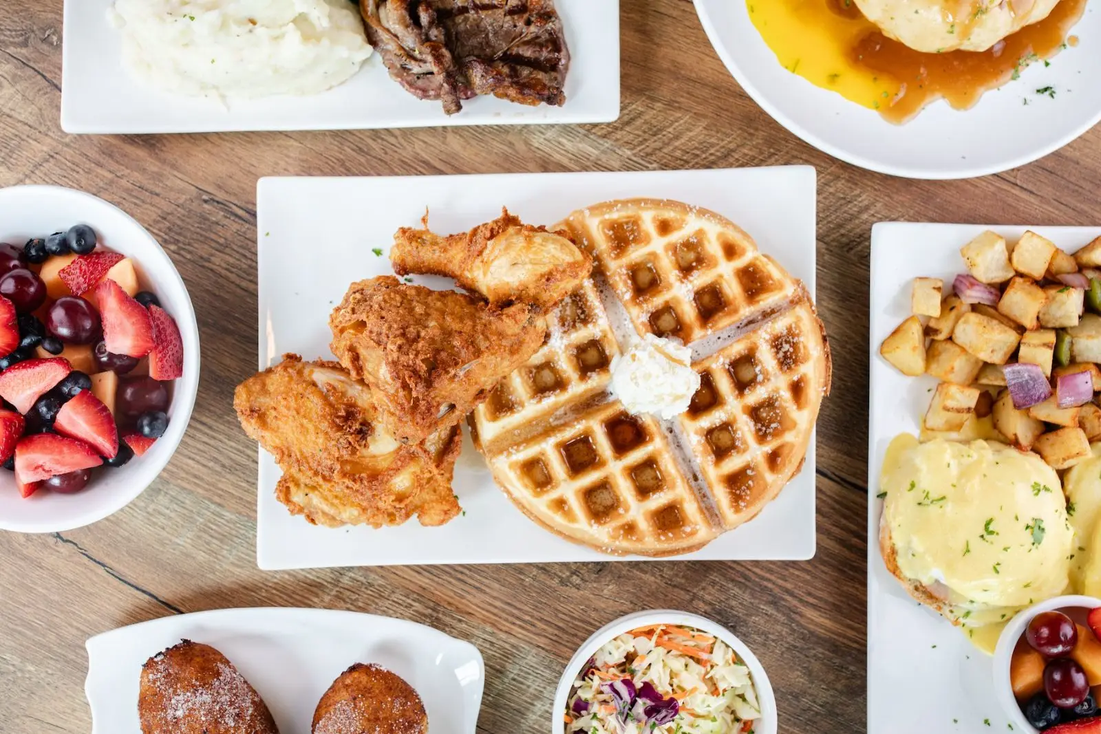 Fried chicken and waffle with fruit and eggs benedict