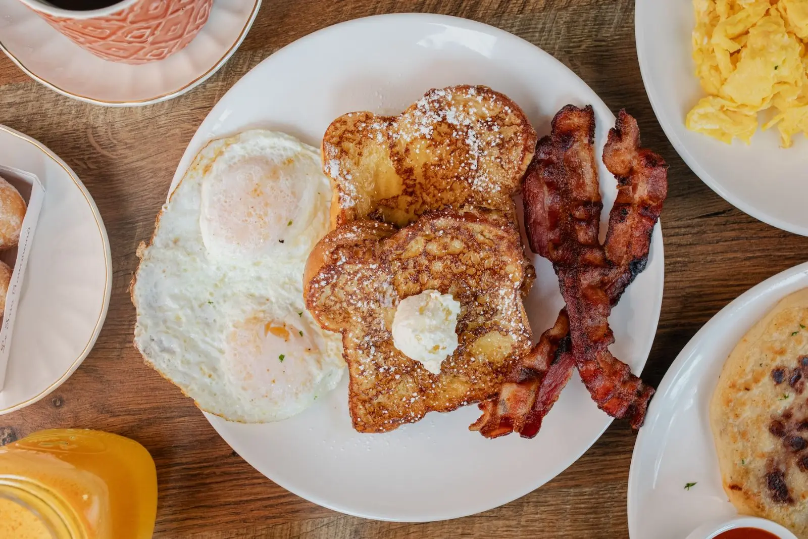 French toast with sunny-side eggs and bacon