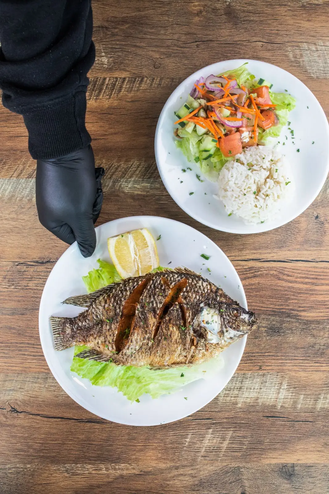 Whole fried fish with rice and salad